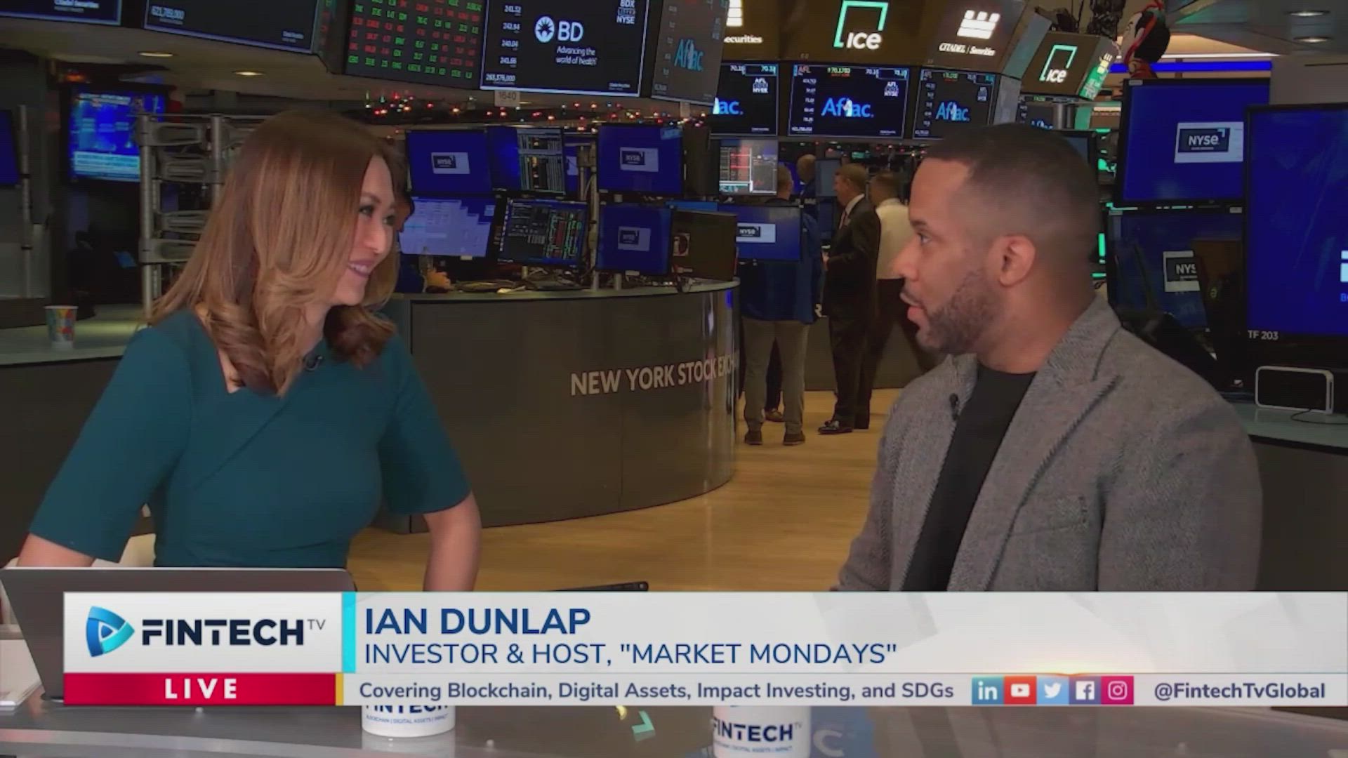 Ian Dunlap interview on Fintech.TV in a NYSE trading floor studio with monitors and ticker boards behind, discussing market conditions