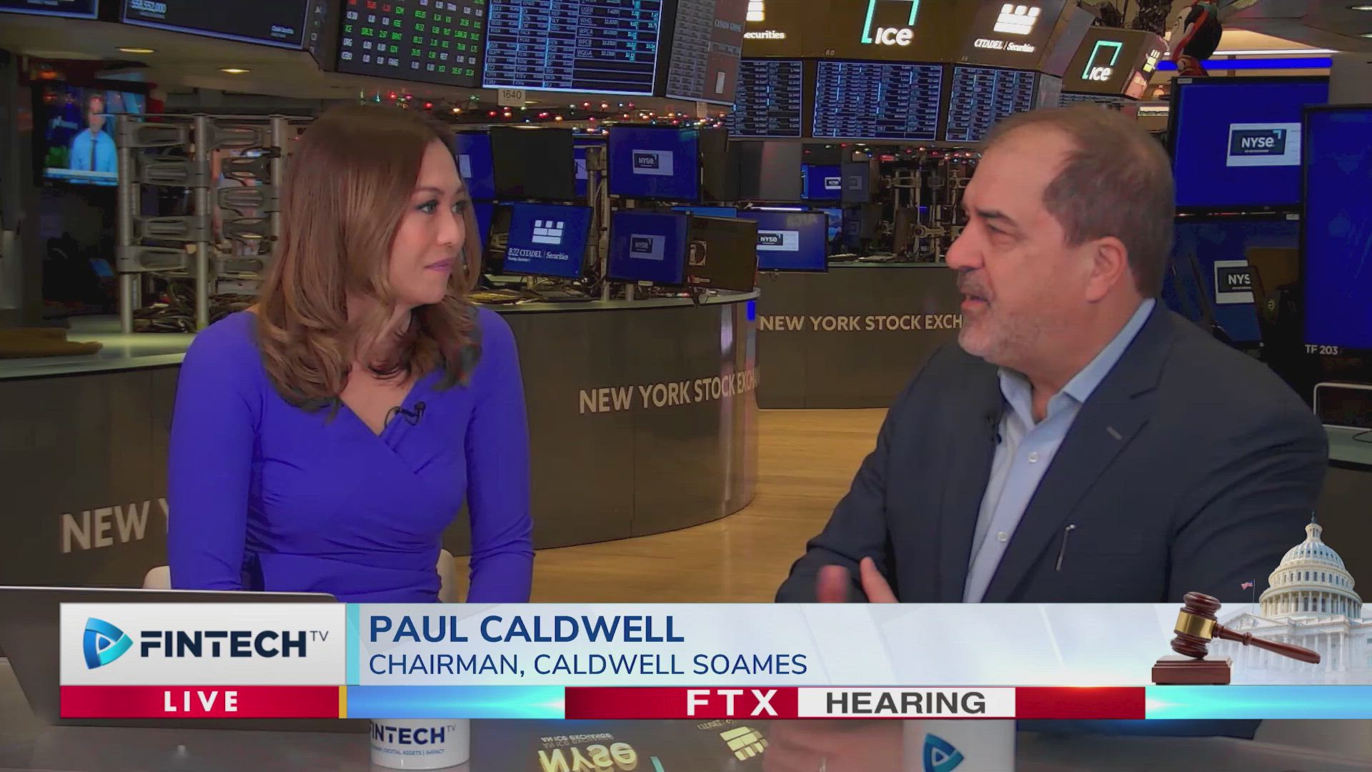 Paul Caldwell, chairman of Caldwell Soames, sits with a host in a FinTech TV studio, wearing blue attire, with NYSE signage and numerous monitors in the background.